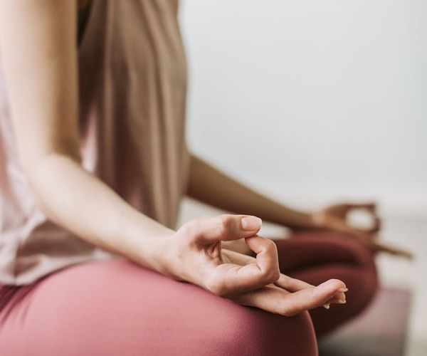 Close-up of hands in a meditative mudra pose.